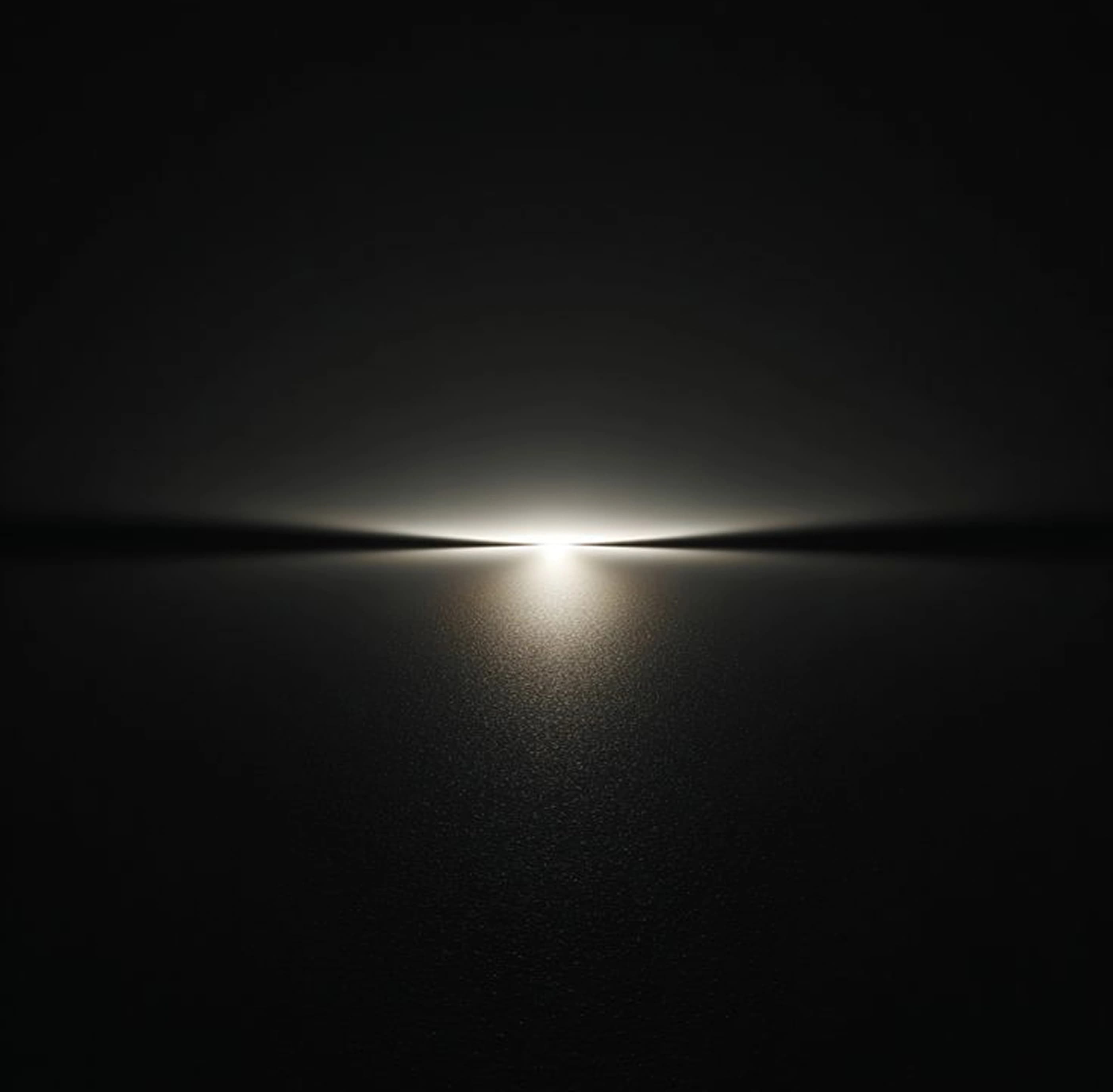 A dark landscape lies under a glowing horizon line at dusk.