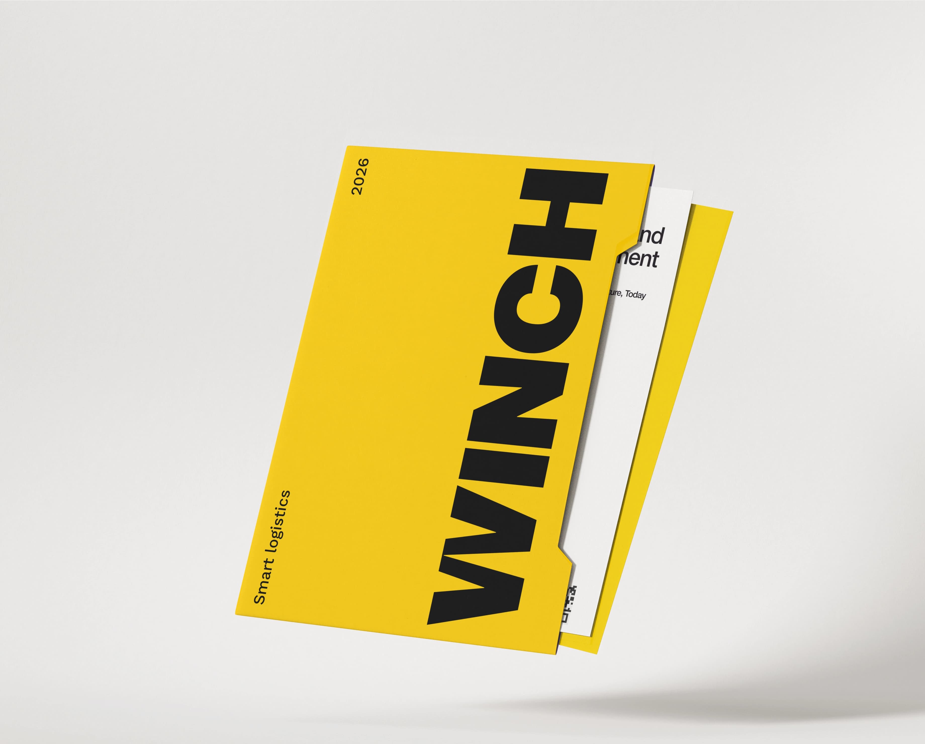 A yellow WINCH presentation folder floating at an angle on a soft grey ground, its cover carrying the vertical black WINCH wordmark with 2026 and Smart logistics set rotated beside it, and a white insert sheet and a yellow sheet protruding from the right edge.